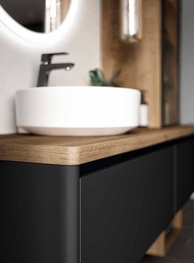 Nahaufnahme eines Waschbeckens Nahaufnahme eines weißen Waschbeckens auf dunklem Schrank